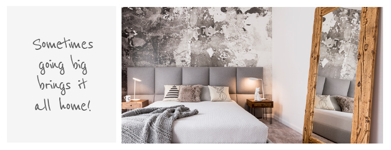 Oversized wooden mirror in grey bedroom setting